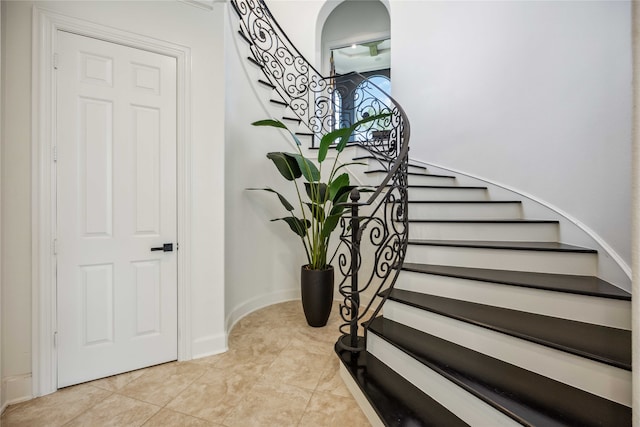 stairway featuring tile patterned floors