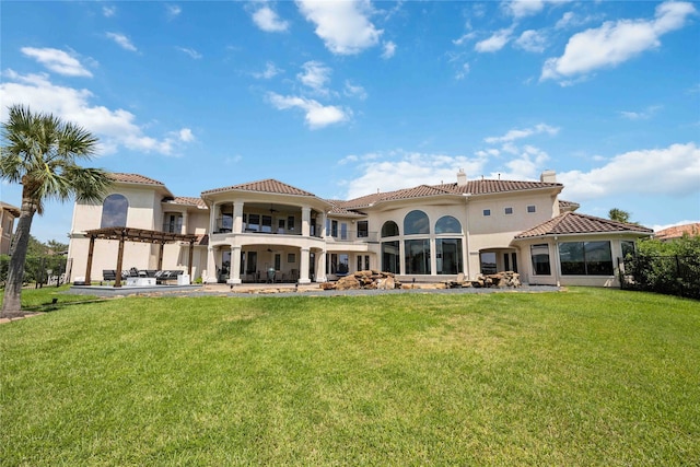 rear view of property featuring a lawn, a balcony, and a pergola