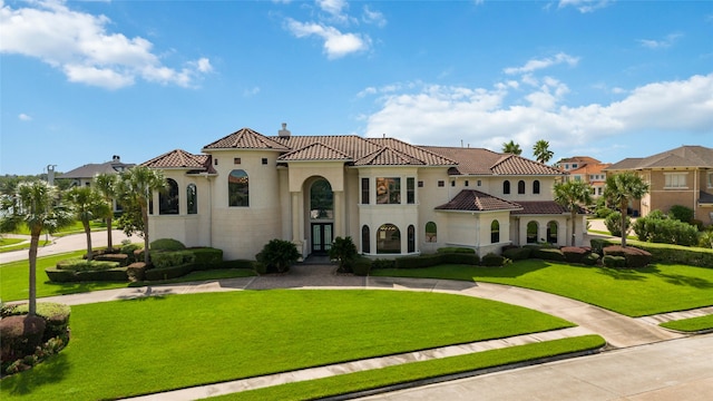 mediterranean / spanish-style home featuring a front lawn