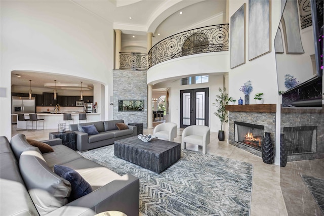 living room with a high ceiling, a fireplace, and an inviting chandelier