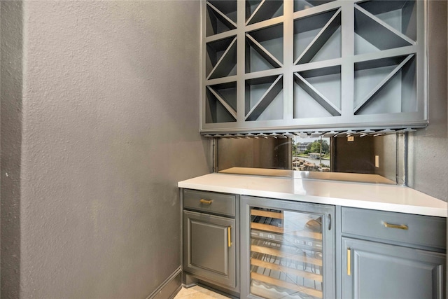 bar featuring gray cabinets and wine cooler