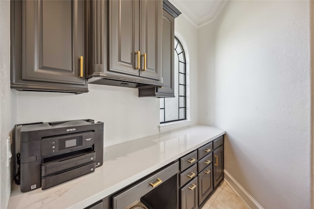 kitchen with ornamental molding and light tile patterned floors