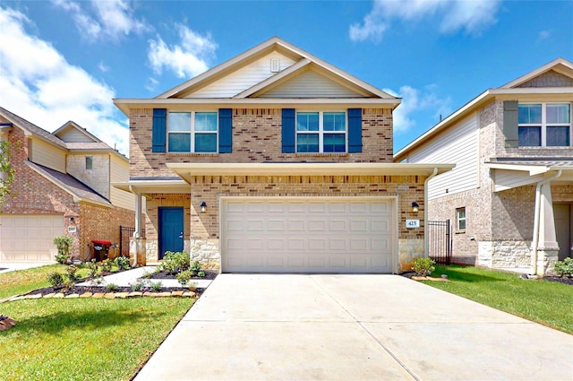 10 Greenbriar Loop, Angleton, TX 77515 - view of front facade featuring an attached garage, driveway, stone siding, and brick siding