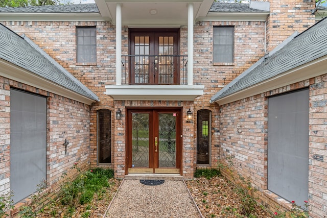 doorway to property with a balcony and french doors