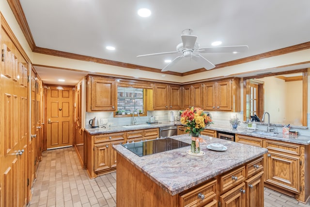 kitchen featuring light stone countertops, sink, ceiling fan, a kitchen island, and decorative backsplash