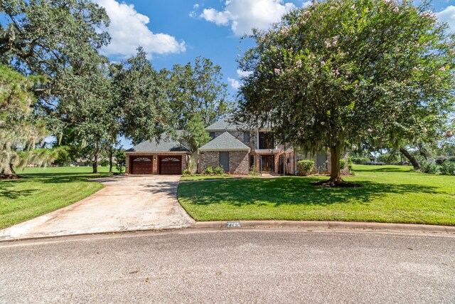 view of front of home featuring a garage and a front yard