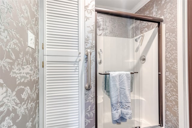 bathroom featuring ornamental molding and walk in shower