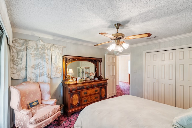 carpeted bedroom with crown molding, a textured ceiling, ceiling fan, and a closet