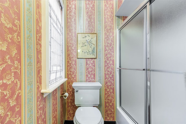 bathroom featuring separate shower and tub and toilet