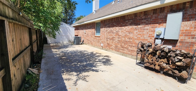 exterior space featuring cooling unit, a patio area, and a shed