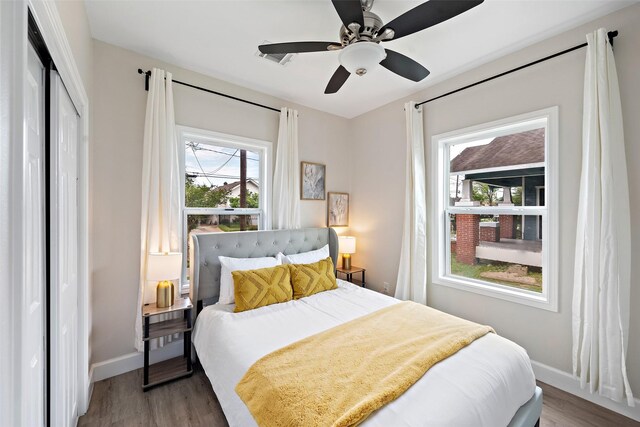 bedroom featuring wood-type flooring, a closet, and ceiling fan