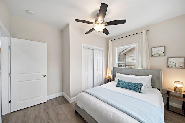 bedroom with ceiling fan, light hardwood / wood-style floors, and a closet