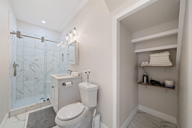 bathroom with a shower with door, vanity, and toilet