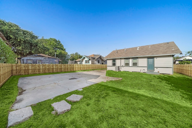 view of yard with central air condition unit and a patio area