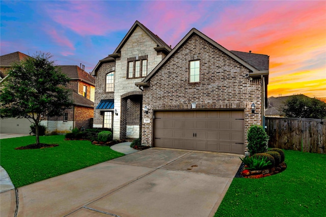 view of front of property featuring a garage and a yard