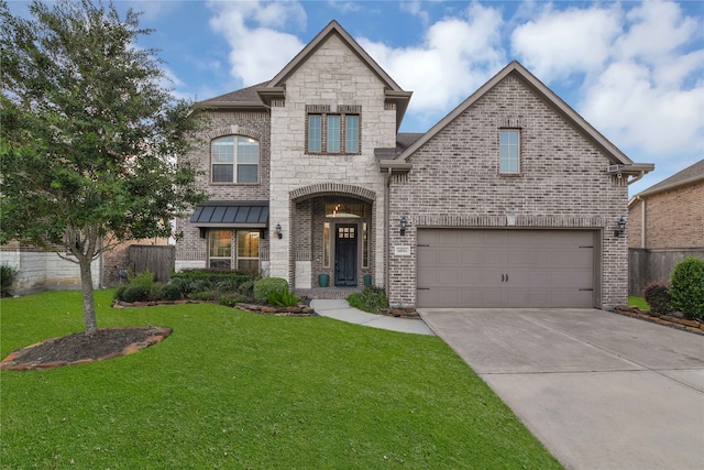 view of front of home with a garage and a front lawn