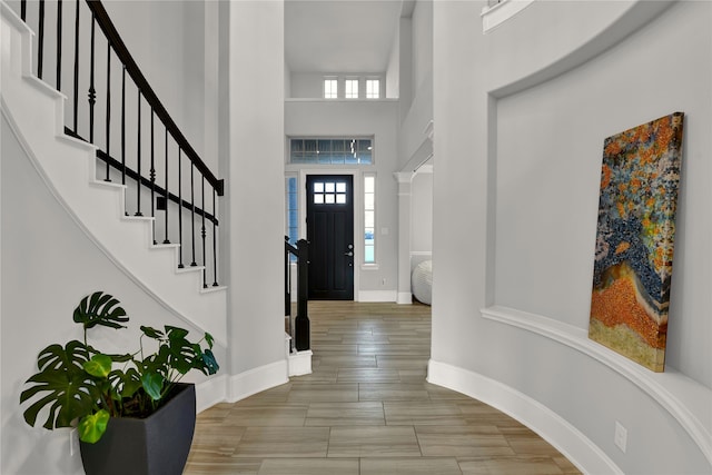 foyer featuring a high ceiling and hardwood / wood-style floors