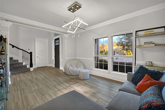 living room featuring crown molding, a chandelier, and hardwood / wood-style flooring