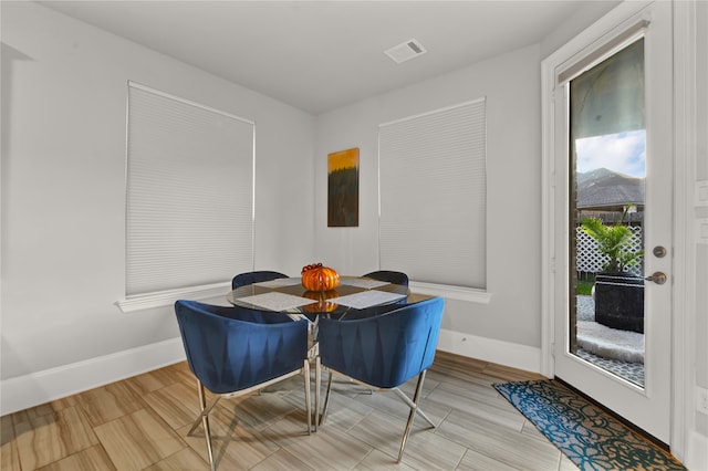 dining space with light hardwood / wood-style floors