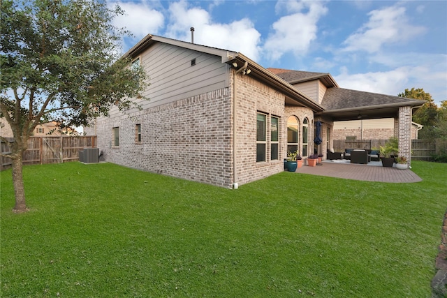 back of house with a patio, central AC unit, outdoor lounge area, and a yard