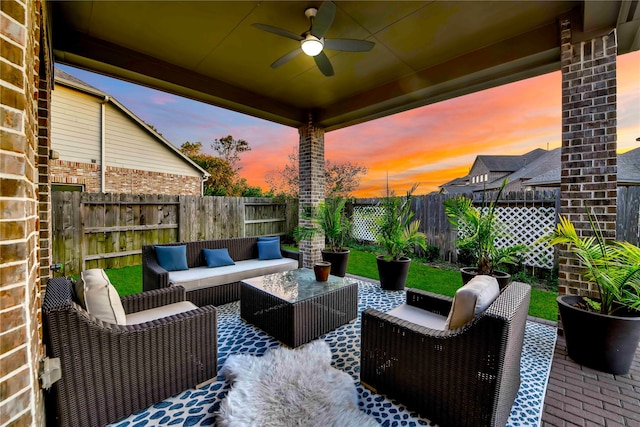 patio terrace at dusk with ceiling fan and outdoor lounge area