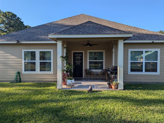 rear view of house with a lawn, ceiling fan, and a patio