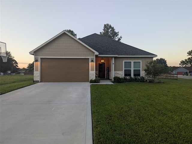 view of front of property with a yard and a garage