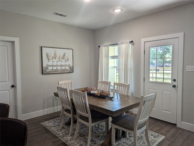 dining space with dark hardwood / wood-style flooring