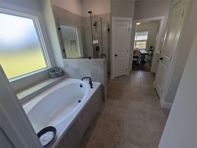 bathroom featuring separate shower and tub and tile patterned flooring