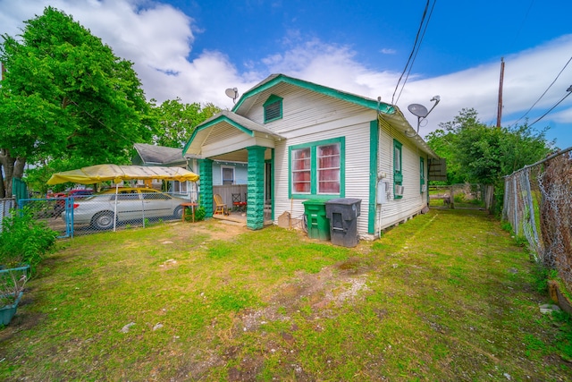 rear view of property with a lawn