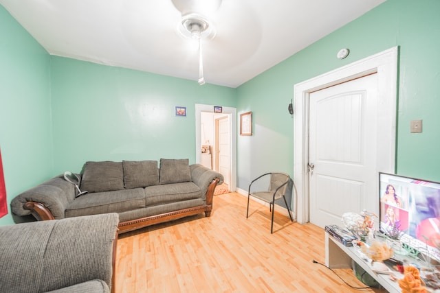 living room featuring ceiling fan and light hardwood / wood-style floors