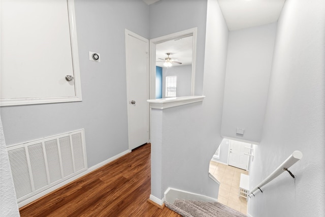 interior space featuring visible vents, ceiling fan, wood finished floors, and baseboards