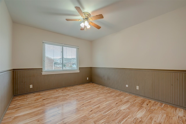 unfurnished room with light hardwood / wood-style flooring and ceiling fan