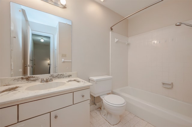 full bathroom with tiled shower / bath, vanity, and toilet