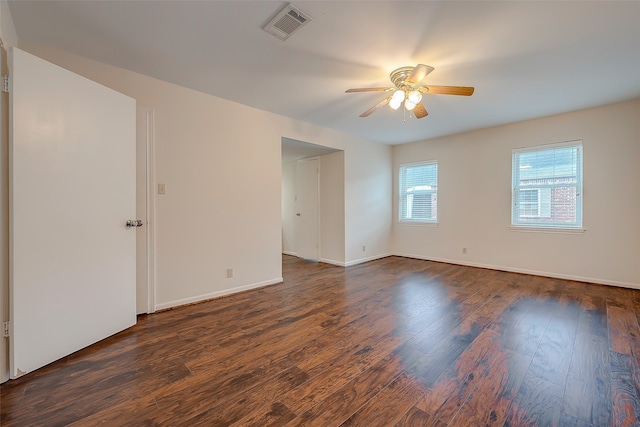 spare room with ceiling fan and dark hardwood / wood-style flooring