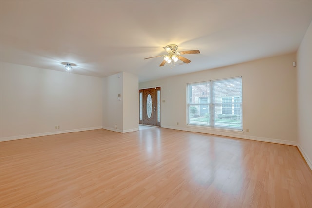 spare room with light hardwood / wood-style flooring and ceiling fan