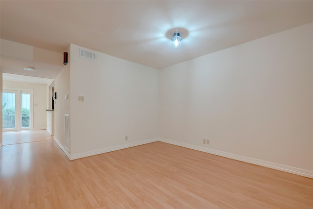 empty room with light hardwood / wood-style flooring