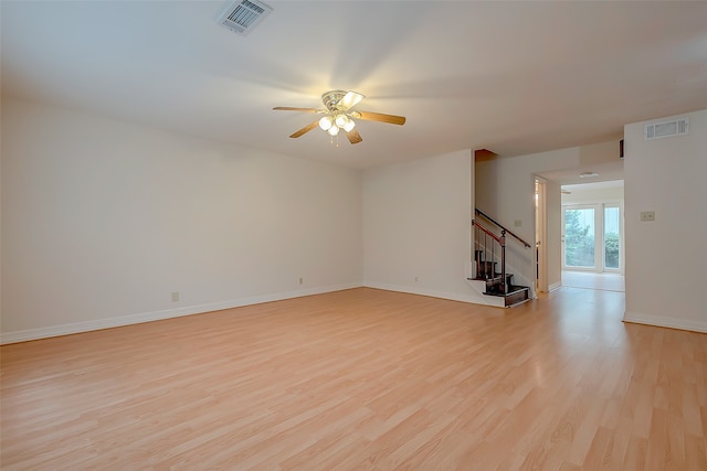 unfurnished living room featuring ceiling fan and light hardwood / wood-style flooring