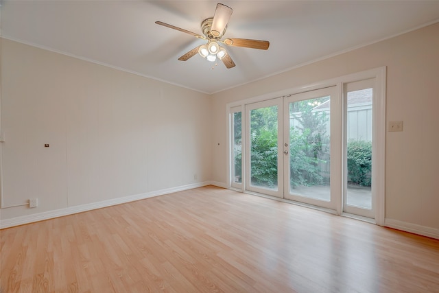 empty room featuring ceiling fan, light hardwood / wood-style flooring, and crown molding