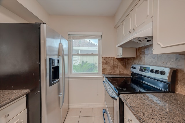 kitchen featuring white cabinets, light tile patterned floors, stone counters, stainless steel appliances, and decorative backsplash