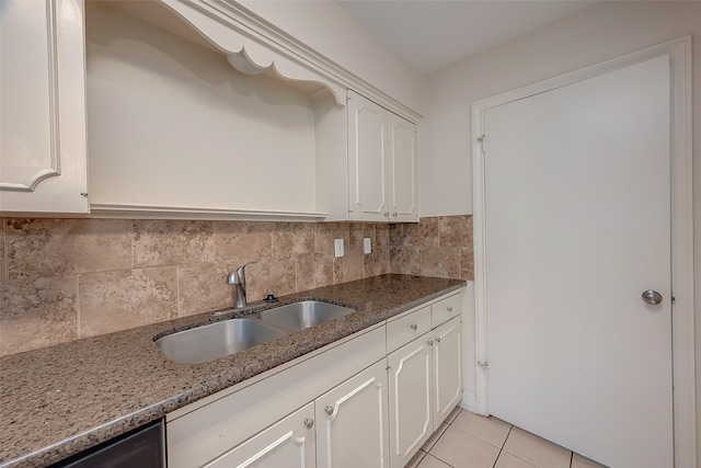 kitchen featuring sink, tasteful backsplash, stone countertops, stainless steel dishwasher, and white cabinetry