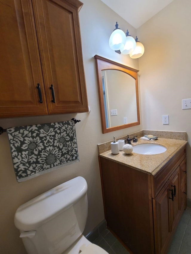 bathroom featuring vanity, toilet, and tile patterned floors