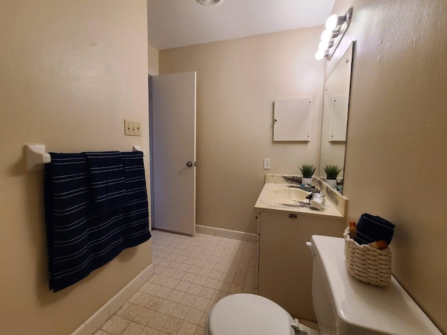 bathroom with vanity, tile patterned flooring, and toilet