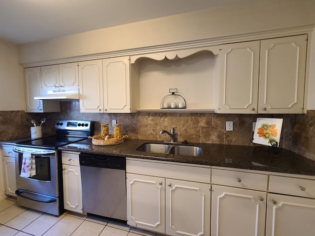 kitchen featuring sink, white cabinetry, decorative backsplash, stainless steel appliances, and light tile patterned floors