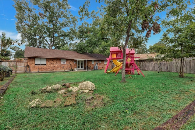 view of yard with central AC and a playground