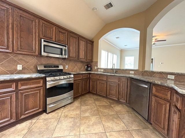 kitchen featuring appliances with stainless steel finishes, crown molding, sink, ceiling fan, and light tile patterned flooring