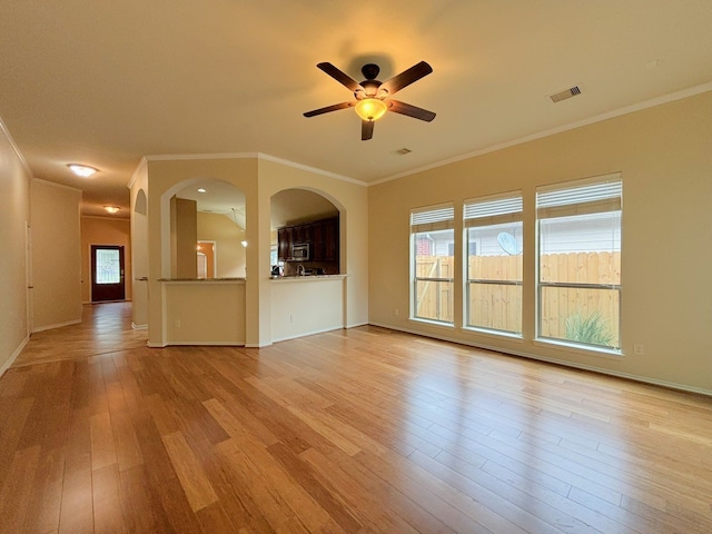 unfurnished living room featuring crown molding, light hardwood / wood-style flooring, and ceiling fan