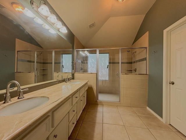 bathroom with lofted ceiling, tile patterned floors, vanity, and a shower with shower door