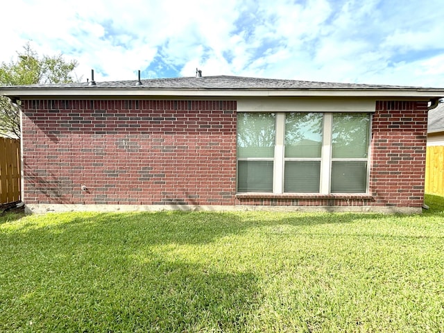 view of side of property with a yard