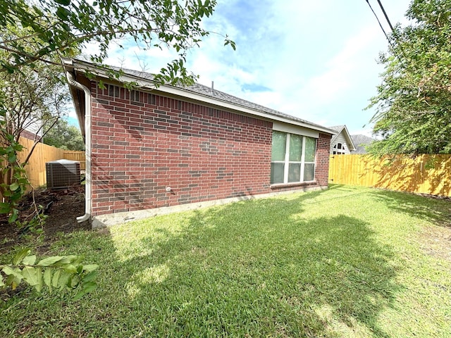 exterior space with a yard and central air condition unit